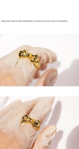 Detail shot of a 3D gold-plated bow ring with high-gloss finish and textured metallic design