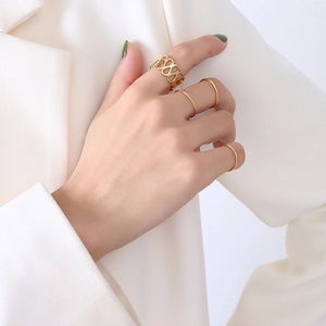 Minimalist 18k gold plated stainless steel ring set shown on model in a stylish hand close-up