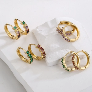 18K gold plated hoop earrings with colorful zircon stones on white marble base