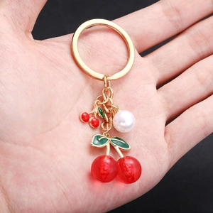 Summer cherry keychain with red resin fruit, green leaves and a white pearl charm