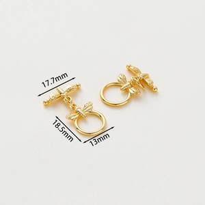 Macro shot of 14k gold-plated dragonfly toggle clasp with precise dimension measurements