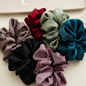 Detail of high-quality satin scrunchies in various Morandi colors with silk-like texture