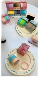 Detail of high-elastic macaron hair ties in a decorative tray with elegant packaging