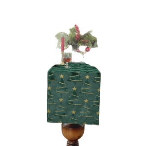 Green plush Christmas table runner with gold tree embroidery and festive decor items