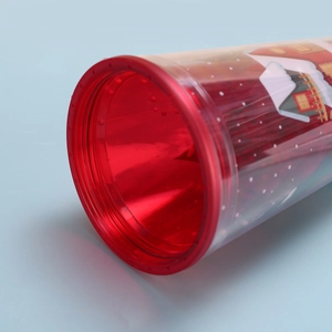 Top view of double-layer plastic Christmas cup with festive pattern and red rim