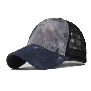 Detail of grey-blue tie-dye fabric and breathable black mesh on the baseball cap