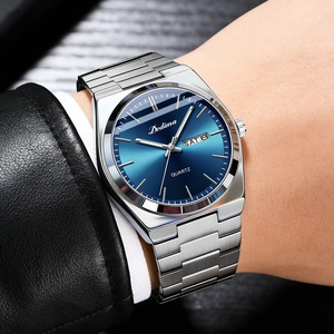 Close-up of elegant men's steel watch featuring a blue dial and dual calendar display