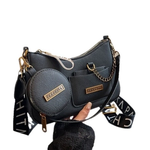 Black Saffiano leather handbag with gold hardware and contrast fabric strap