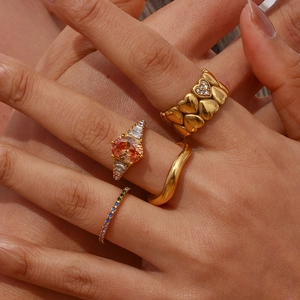 Detail shot of 18K gold plated stacked rings set featuring heart shapes and crystals