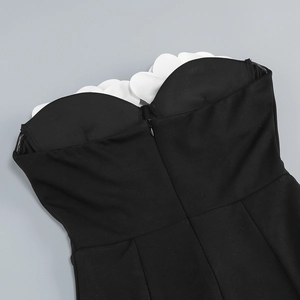 Detail of strapless neckline with white 3D wavy trim and invisible back zipper on dress