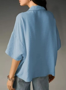 Back view of a light blue short-sleeved casual shirt with smooth silk-like fabric texture
