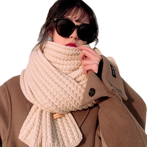 Thick beige knitted scarf for women with handmade leather tag and cozy winter texture