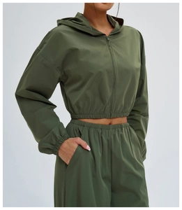 Detailed texture of army green sun protection fabric and zipper on outdoor jacket