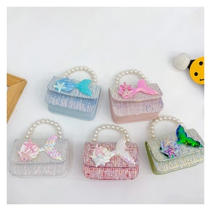 Detail of tweed sequin mini bags with pearl handles and mermaid tail patches
