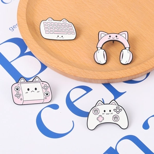 Cute pink and white cat-themed gaming enamel pins set featuring a keyboard and headset