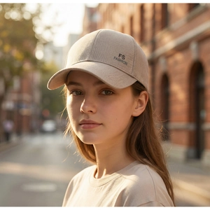 Detail of light beige cotton baseball cap with FS FASHION side embroidery on urban street