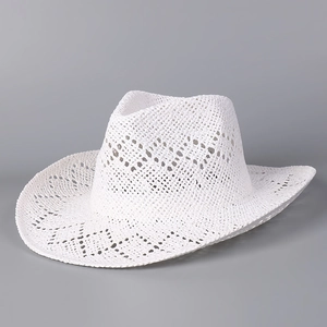 Detail showing the intricate hollow-out weaving and texture of the white straw cowboy hat