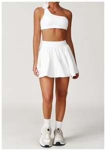 Detail view of white tennis skirt featuring high-waisted pleated hem and quick-dry fabric