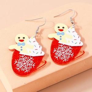 Detailed close-up of festive gingerbread man and snowflake acrylic Christmas earrings