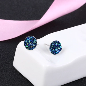 S925 silver round stud earrings featuring blue and green crystals on a display