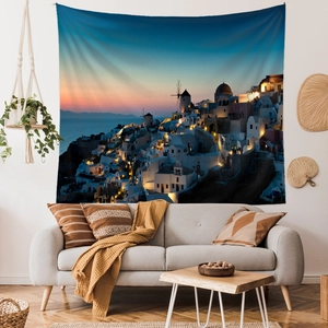 Detail of Santorini landscape wall tapestry showing white architecture in a cozy living room