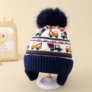 Close-up of winter knit hat for boys featuring colorful excavator patterns and earflaps