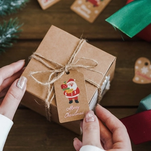 Brown kraft paper Christmas tags with Merry Christmas print and festive jute string decor