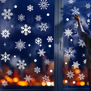 White snowflake static window stickers for Christmas glass decoration with festive lights