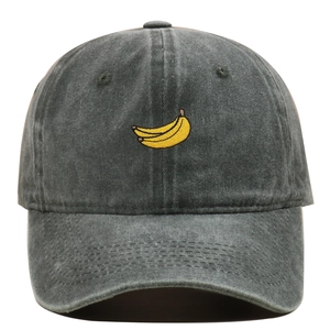 Detailed close-up of yellow banana embroidery on a washed grey cotton baseball cap