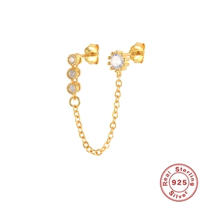 Detail of 925 sterling silver earring with gold chain and sparkling round zircon stones