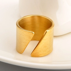 Macro shot of gold stainless steel ring featuring horizontal brushed metal texture