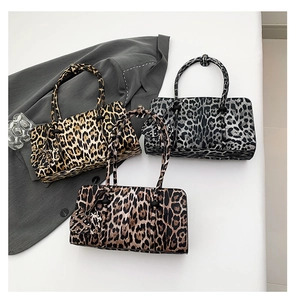 Chic leopard print handbags in tan, grey, and brown displayed with stylish blazer