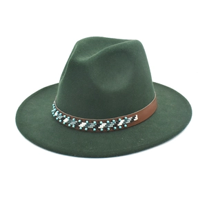 Détail d'un chapeau fedora en laine vert foncé avec bande en cuir et perles ethniques