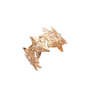 Golden starfish open bangle featuring continuous sea star patterns with white pearl accents