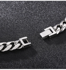 Macro shot of 10mm polished stainless steel Cuban chain with square box clasp detail