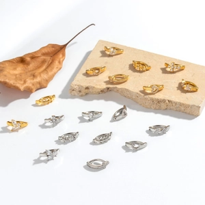 Collection of creative gold and silver navel piercing rings with heart and cross charms