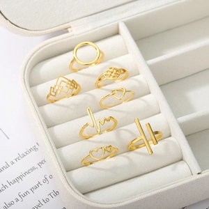 Detailed view of a 7-piece 18k gold plated ring set with heart and geometric patterns