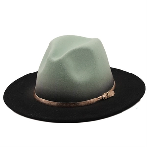Detail of ombre mint green and grey fedora with wide black brim and golden buckle belt