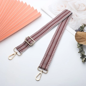 Adjustable brown and white herringbone strap with gold metal hooks for handbags