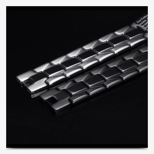 Macro detail of black and silver stainless steel watch link bracelets with engraved text