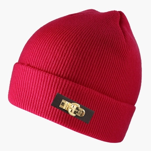 Detail of dark red knit beanie featuring a leather patch with a golden metal 1999 buckle