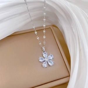 Macro view of silver flower pendant set with clear crystals on luxury necklace