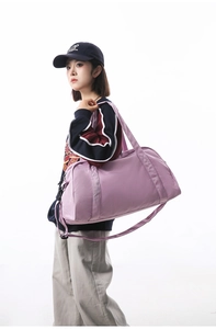 Large purple sports gym bag carried by a model to show its actual size and style