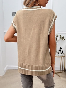 Detail of camel knit sweater vest featuring white striped ribbed V-neck and armholes