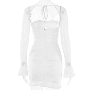 Detail of white backless dress featuring lace-up ties, ruched fabric, and shimmery texture