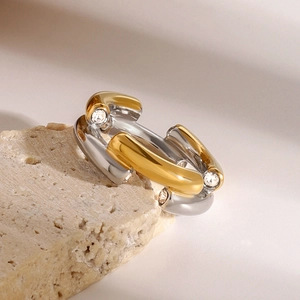 Elegant two-tone gold and silver stainless steel ring with zircon on a natural stone