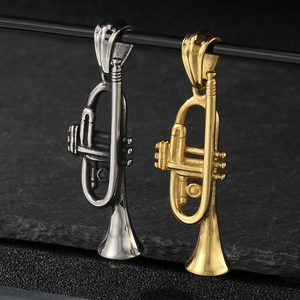 Detailed view of trumpet pendants in silver and gold finishes on a textured dark background