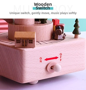 Detail of wooden music box showing the mechanical switch and decorative miniature houses