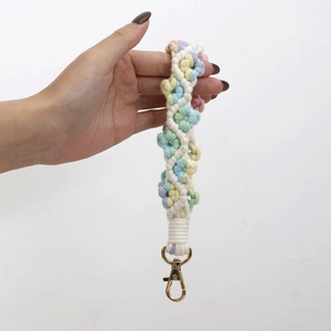 Macro shot of colorful crochet floral wrist strap with a gold metal lobster clasp