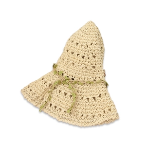 Detailed macro view of cream hollow-out straw hat with green leaf ribbon accent